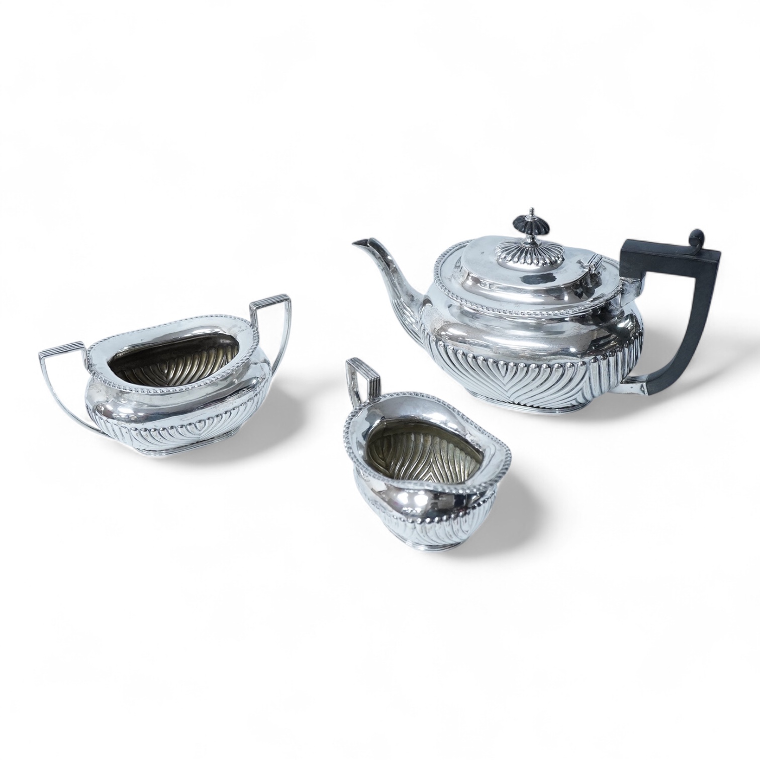 A late Victorian demi-fluted silver oval three piece bachelor's tea set, by James Deakin & Sons, Chester, 1893, gross weight 15.7oz.